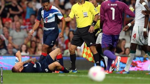 Neil Taylor looks on in concern after Craig Bellamy is flattened