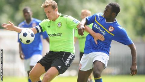 Jamie Collins of Forest Green Rovers competes with Cardiff City’s Jessie Darko