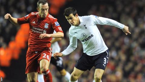 Charlie Adam (left) tussles with Gareth Bale in a league match at Anfield in February