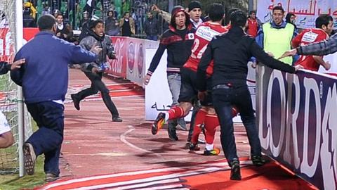 Al Ahly players leave the pitch at Port Said
