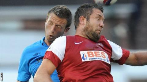 Fleetwood striker Jon Parkin (r) beats Nottingham Forest's Danny Collins to a header