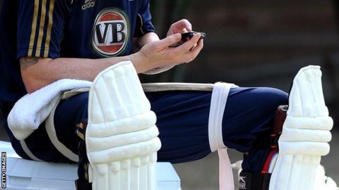 Cricketer using mobile phone