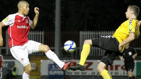 St Pat's player Jake Carroll competes against Mark Brolly of Derry City