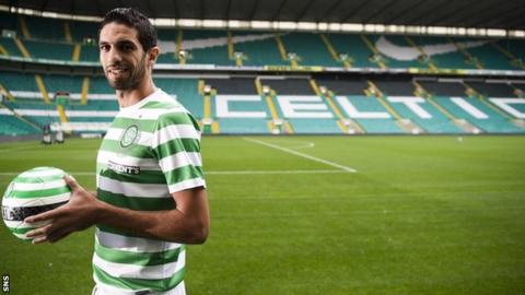 Lassad Nouioui tries on his new strip at Celtic Park