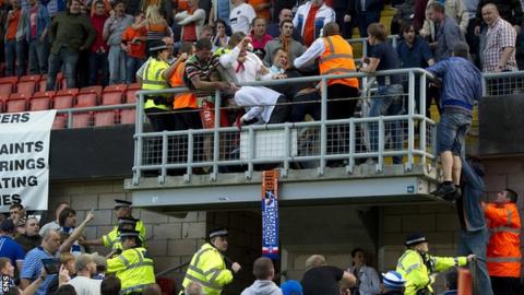 Police and stewards intervene as fans battle at Tannadice