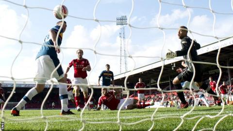 Magennis sends the ball into the Motherwell net in stoppage time