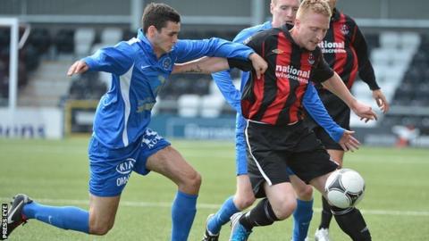 Ballinamallard's Stuart Hutchinson in action against Chris Morrow of Crusaders