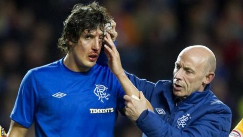 Rangers forward Francisco Sandaza receives treatment on an injury