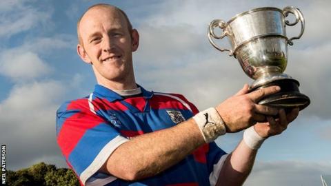 Kingussie captain Grieg Macrae holds aloft the Sutherland Cup after the win over Glenurquhart at Braeview, Beauly.