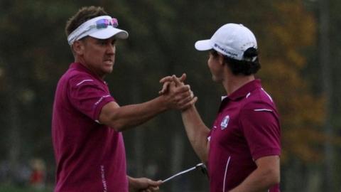 Ian Poulter and Rory McIlroy celebrate winning a crucial point for Europe