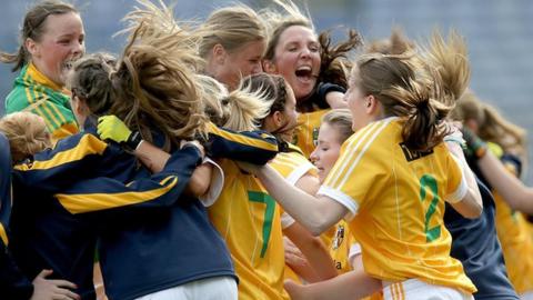 Antrim players celebrate after winning the Junior final