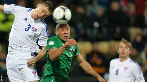 Pól Jóhannus Justinussen of the Faroe Islands in action against the Republic of Ireland's Jon Walters