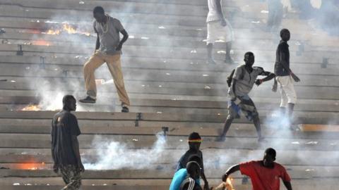 Senegalese fans riot in the stands at the Stade Leopold Senghor on Saturday
