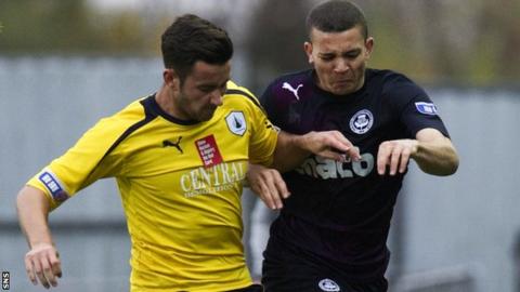 Falkirk's Jonathan Flynn (left) holds off Aaron Sinclair