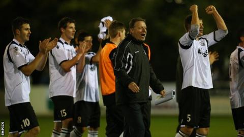 Cambridge City's management and players celebrate