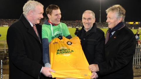 First Minister Peter Robinson and deputy First Minister Martin McGuinness with John McAreavey, husband of Michaela McAreavey, and Tyrone manager Mickey Harte, Michaela's father, at Casement Park