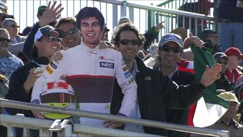 Fans pose with a cardboard cut-out of Sergio Perez