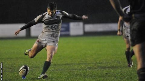 Scott Davidson kicks the winning penalty for Guernsey