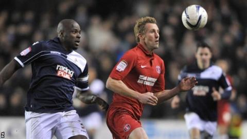Millwall's Danny Shittu (l) challenges Charlton's Rob Hulse