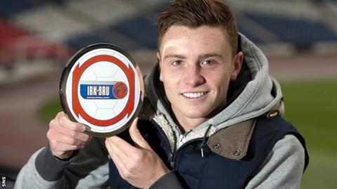 Rangers midfielder Lewis MacLeod shows off his award