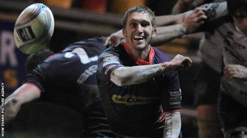 Wayne Evans passes the ball