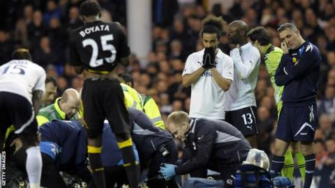 Owen Coyle looks on anxiously as Fabrice Muamba receives treatment