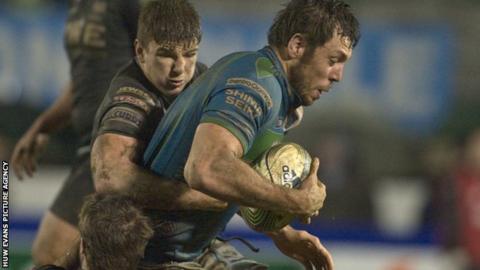 Treviso's Valerio Bernabo is tackled by Sam Lewis and Campbell Johnstone