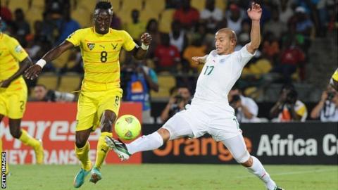 Algeria midfielder Adlene Guedioura (R) challenges Togo's Komlan Amewou