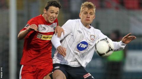 Cliftonville's Tomas Cosgrove is challenged by Coleraine opponent Aaron Boyd