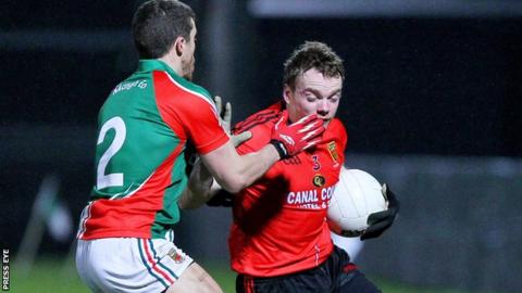 Mayo Chris Barrett challenges Brendan McArdle