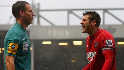 Mark Clattenburg and Adam Lallana