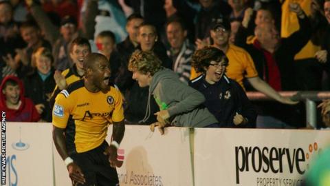 Aaron O'Connor celebrates in front of Newport supporters