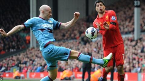 West Ham defender James Collins (left) foils Liverpool striker Luis Suarez