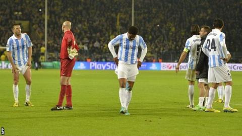 Malaga players after their defeat
