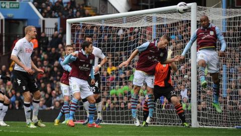 Aston Villa midfielder Fabian Delph heads into his own net against Fulham