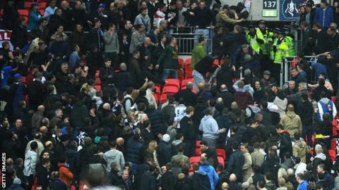 Violence erupts in the Millwall end in the FA Cup semi-final against Wigan at Wembley