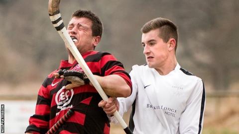 Oban's Ian Campbell winces in a challenge with Lovat's Lewis Tawse