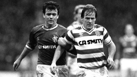 Celtic midfielder Murdo MacLeod is trailed by Rangers winger Davie Cooper