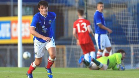 Philip Lowry prepares to celebrate after he scores Linfield's third goal
