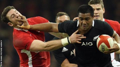 New Zealand's Julian Savea hands off Wales' Alex Cuthbert in 2012