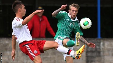 Northern Ireland's Kirk Millar with Denmark's Jonas Knudsen