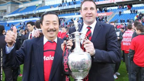 Malky Mackay and Vincent Tan with the Championship trophy