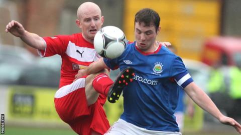 Cliftonville's Ryan Catney challenges Linfield midfielder Jamie Mulgrew