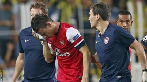 Arsenal defender Laurent Koscielny walks off after suffering his injury against Fenerbahce