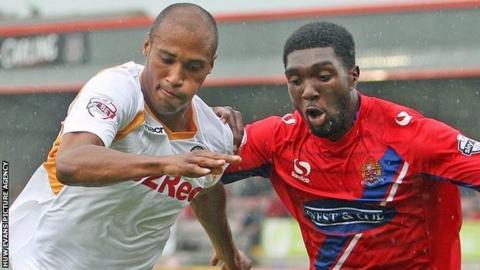 Chris Zebrowski of Newport (left) attacks Dagenham & Redbridge