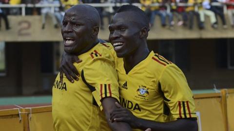 Uganda's Geoffrey Massa (left) with Emmanuel Okwi