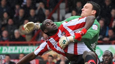 Clayton Donaldson and Portsmouth keeper Simon Eastwood