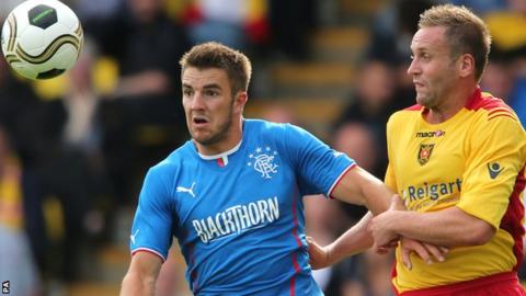 Andy Little holds off Albion Rovers opponent Ciaran Donnelly