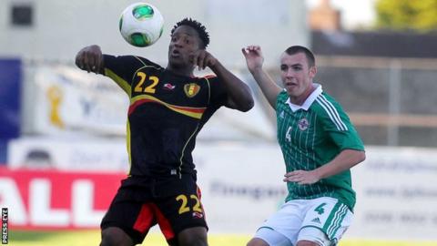 Northern Ireland's Luke McCullough is about to challenge Belgian goalscorer Michy Batshuayi