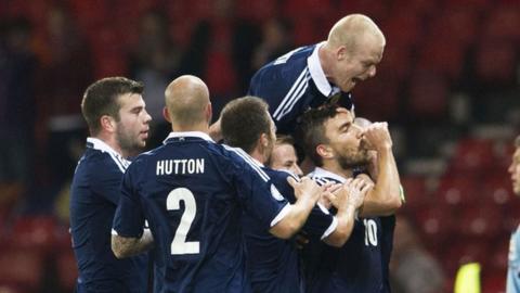 The Scotland players congratulate Robert Snodgrass on his goal